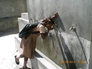 Getting a drink at the school cistern